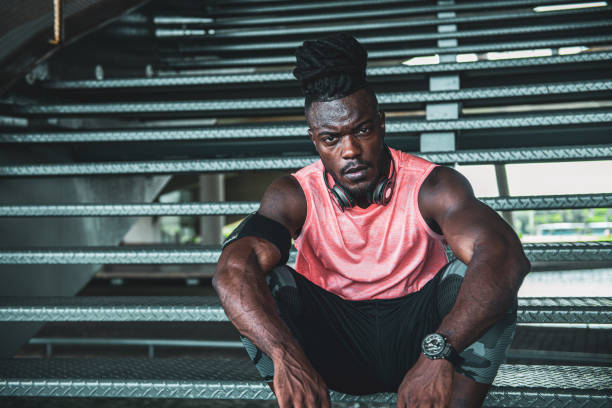 istock Afro young athletic man resting on a staircase 1341975589