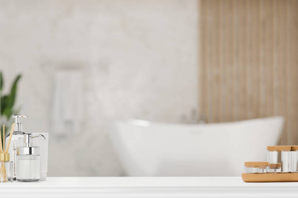 white tabletop with luxury toiletries product over blurry elegance bathroom - hotel shampoo stockfoto's en -beelden