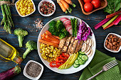 istock Healthy eating and diet concepts. Top view of spring salad shot from above on rustic wood table. 1341976416