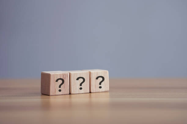 istock Questions Mark word in wooden cube block on table background. 1341977856