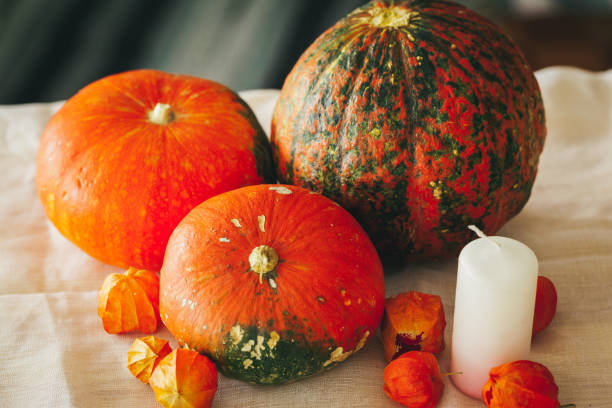 istock Autumn background with pumpkin close up on table 1341980251