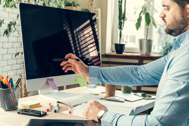 istock Businessman looking at computer monitor during working day in office 1341982540
