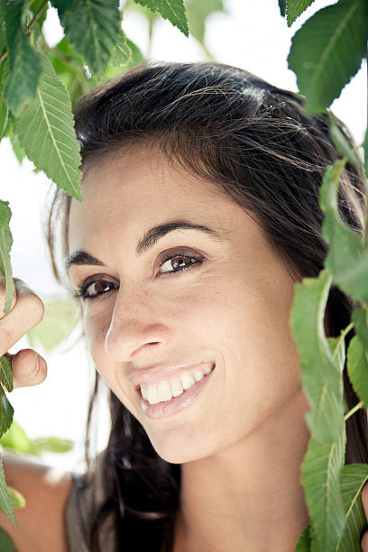 istock Smiling Beauty through the leaves 134198272