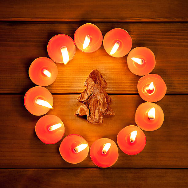 istock christmas candles circle over wood and symbol 134198310