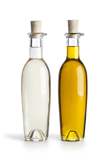 Two corked bottles of oil and vinegar on white background Bottles with oil and vinegar on white background vinegar bottle stock pictures, royalty-free photos & images
