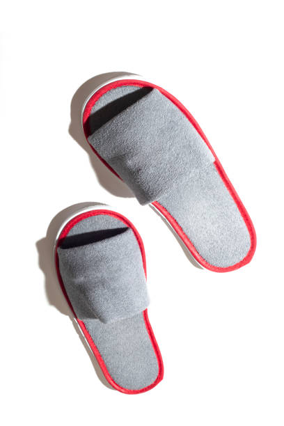 istock Gray one-off slippers for hotel on a white background 1341985450
