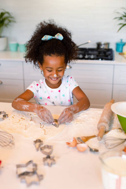 istock Happy african american messy girl baking in kitchen 1341987134