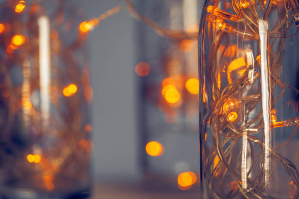 istock Lights garland in a glass bottle on a dark background 1341988105