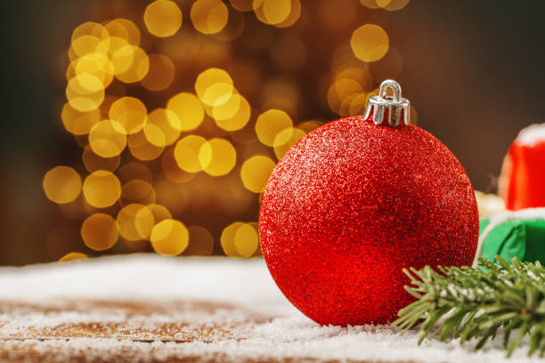 istock Snowy table with christmas bauble decoration close up 1341989651