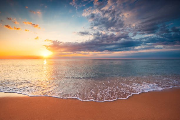 istock Beautiful cloudscape over the sea  waves and beach, sunrise shot 1341994955