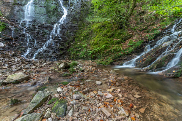 istock Waterfall in the mountain in early fall. 1341995660