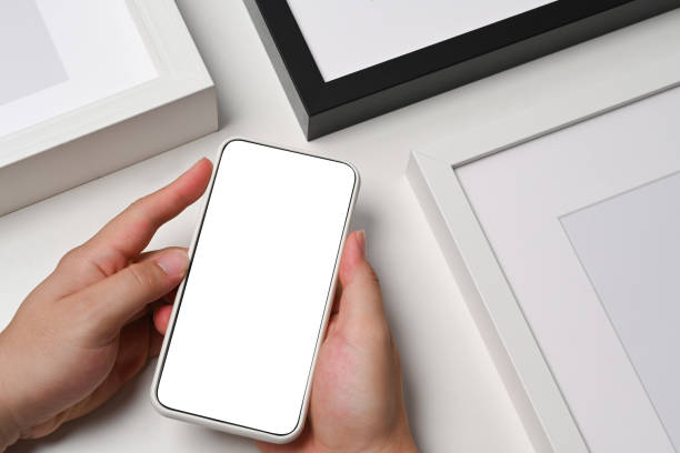 istock Close up view man holding smart phone with blank display. 1341996466