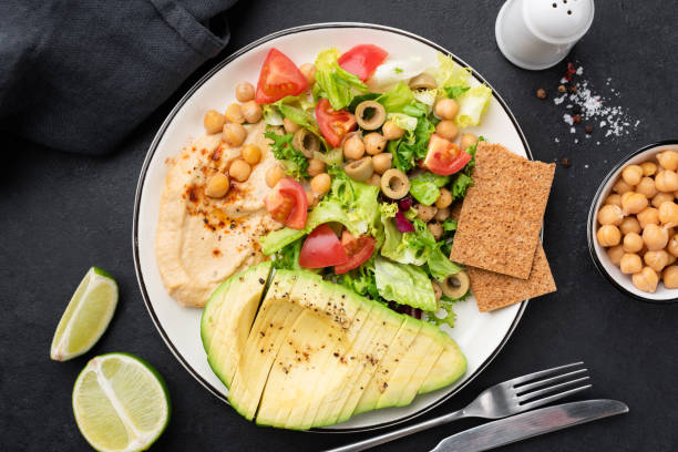 istock Healthy salad with avocado, hummus and vegetables 1341998479