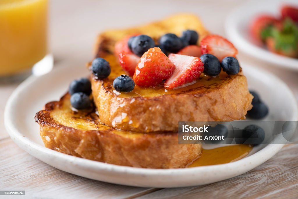 French toast with berries and honey French toast with berries and honey on plate, closeup view, selective focus French Toast Stock Photo