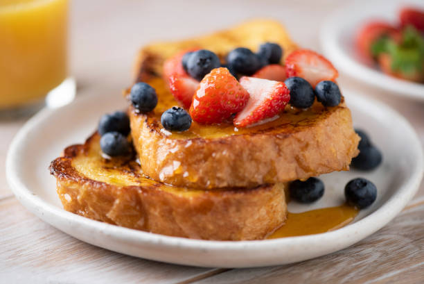 French toast with berries and honey French toast with berries and honey on plate, closeup view, selective focus honey crisp stock pictures, royalty-free photos & images