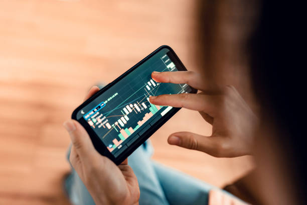 istock Woman is checking Bitcoin price chart on digital exchange on smartphone, cryptocurrency future price action prediction. 1341998689