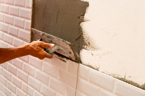 istock House renovation, Laying ceramic tles on the wall. 1341998847
