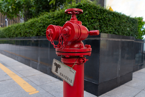 Fire hydrant yellow color in the city center, closeup. Fire fighting equipment, blur urban background