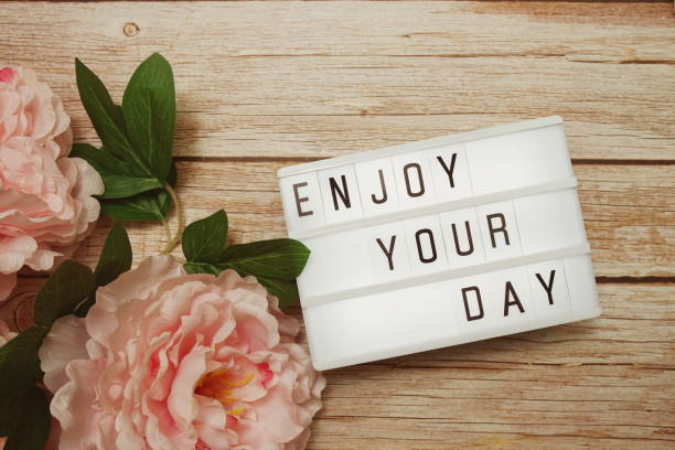 istock Enjoy Your Day text on lightbox on wooden background 1341999882