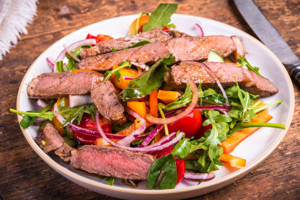 istock Healthy vegetable salad with beef steak on a plate, rustic style, close-up 1342000467