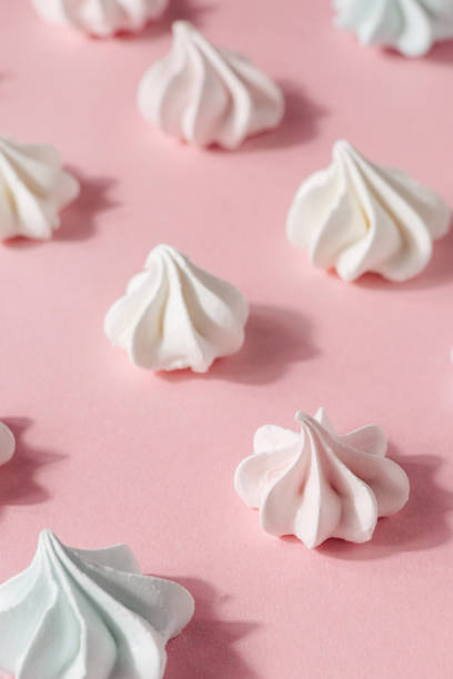 istock Pink and white meringue, zephyr, marshmallow, on pink background, selective focus 1342001364