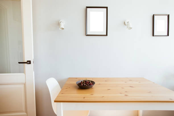 istock Cherry berries on plate on wooden table in modern kitchen. Interior design and mock up pictures on wall 1342001380