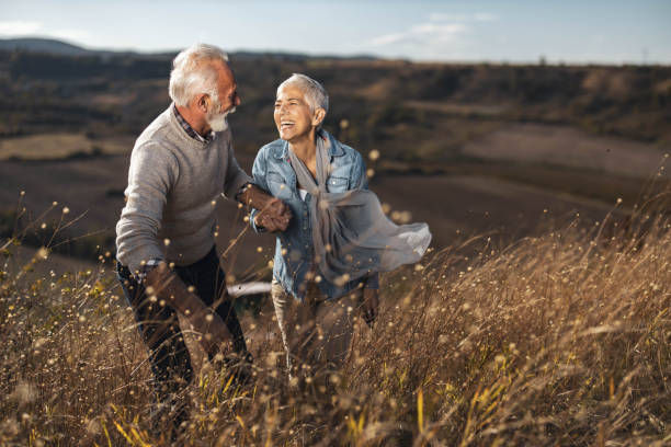 istock Happy mature couple talking while walking up the hill in nature. 1342002318