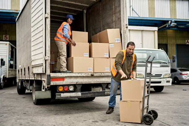istock Warehouse Worker and Truck Driver Loading Delivery Vehicle 1342002628
