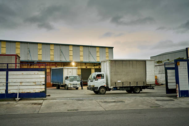 Construction Site With Empty Car Trailer And Building Materials Stacked On Pallets.