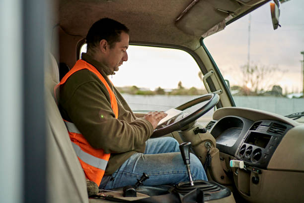 istock Male Truck Driver Sitting in Cab Using Digital Tablet 1342002647