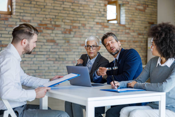 istock Human resource team having a job interview with male candidate. 1342003508