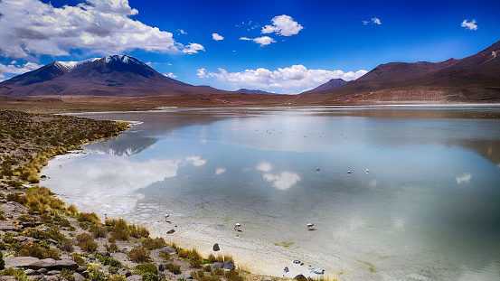 Aerial view of Lagoon Hedionda water reflection mountain and flamingo in Bolivia
