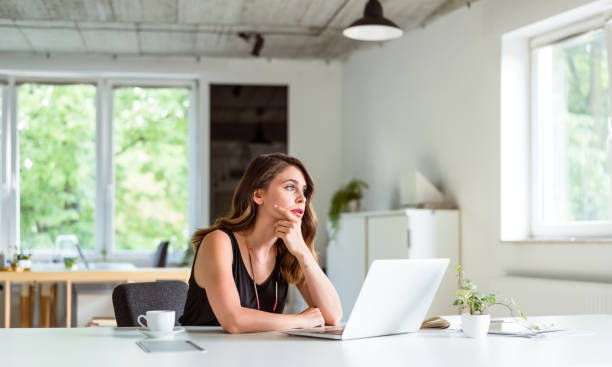 istock Young woman working on computer in the office 1342004636