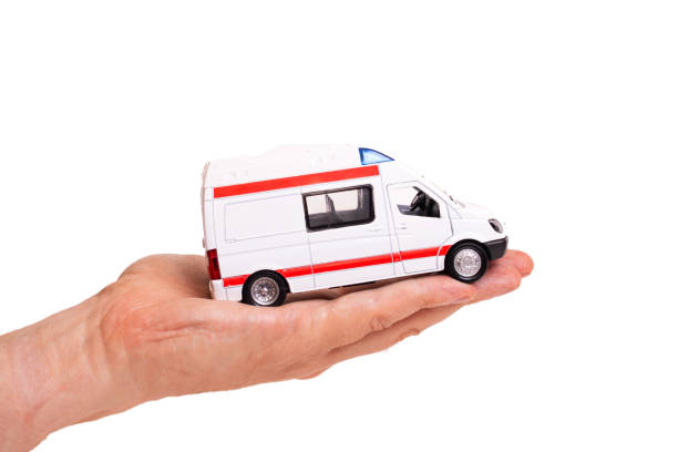 istock Toy ambulance car on palm isolated on white background 1342005377