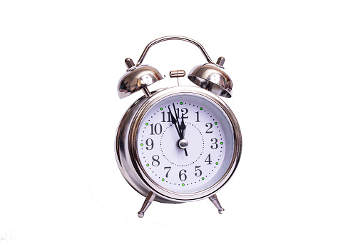 Metal retro alarm clock isolated on white background close up