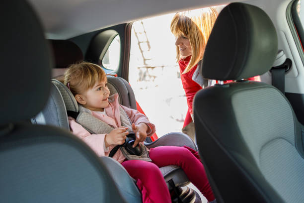 istock Woman checking her daughter sitting in a car seat 1342006558