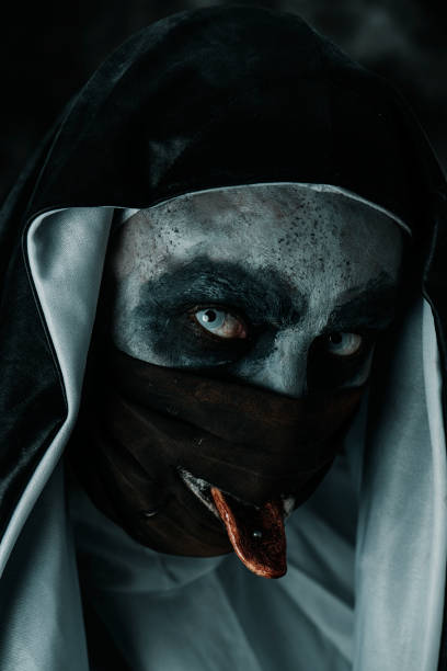 istock evil nun sticking out her pierced tongue 1342009217