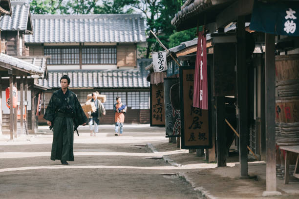 Traditional Japanese samurai Traditional Japanese samurai walking in Edo period town historical reenactment stock pictures, royalty-free photos & images