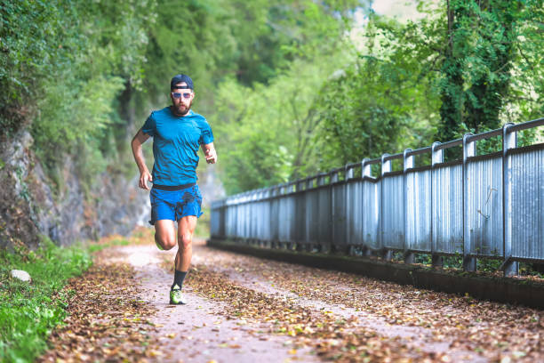 Man marathon runner during preparation on bike path Man marathon runner during preparation on bike path intermission stock pictures, royalty-free photos & images