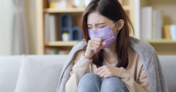 asian woman sick and cough in the living room at home