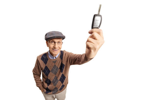 istock Elderly happy man showing a car key in front of camera 1342014527