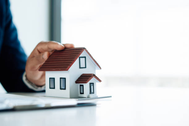 istock Buying a Home or Insurance, an insurance agent explains the lease agreement to a client before making a contract. Mortgage loan approval home loan and insurance concept. 1342016332