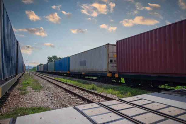 istock Train with container cargo boxes at railway station transport logistic distribution goods is industry transportion business concept. 1342016383