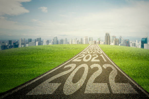 istock Empty road with 2022 numbers toward modern city 1342021040
