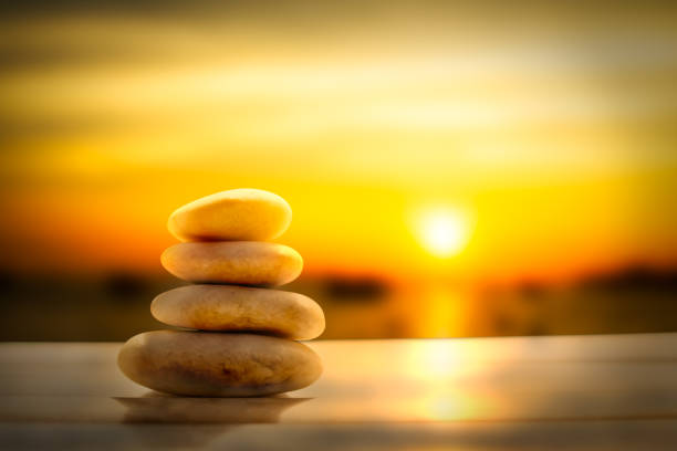 istock Stack pyramid stone zen pebbles nature on wooden with blur sun set on sea. 1342021278