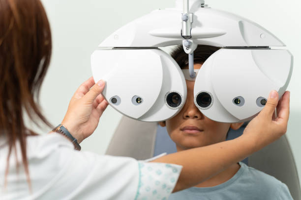 istock Asian boy with a phoropter at an optometrist consultation 1342022672
