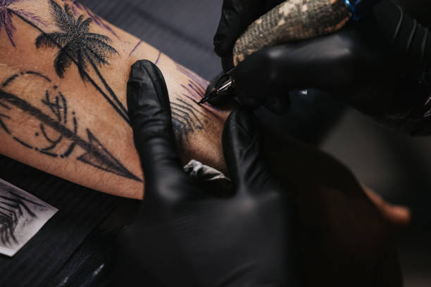 istock Tattoo artist tattooing a male model 1342023662