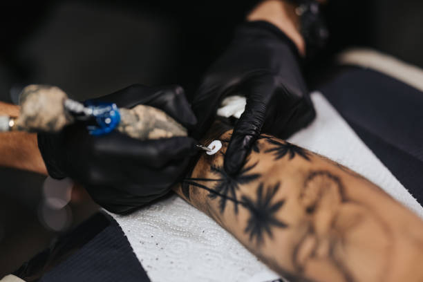 istock Tattoo artist tattooing a male model 1342023751