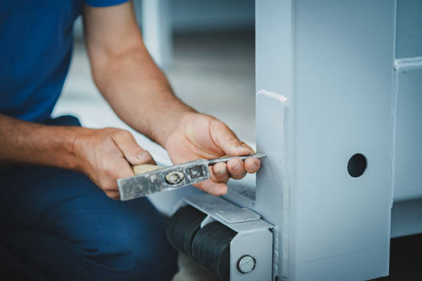 istock Worker with a hammer and chisel makes a hole in the metal 1342023933