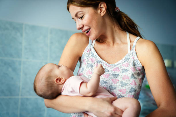 istock Happy mother and baby hugging and playing together. 1342024191